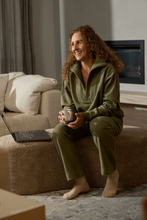 Load image into Gallery viewer, Goondiwindi Cotton - Rugged ½ Zip Cotton Sweater - Sage colour, model sitting in a couch
