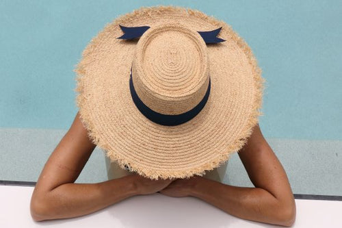 Peta - Raffia Boater Navy Ribbon Band wore by a model